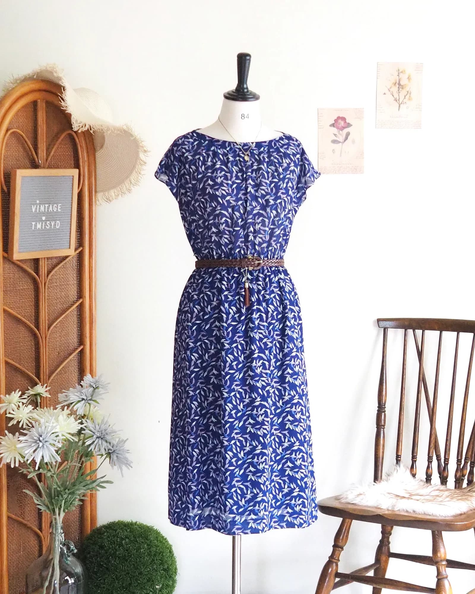 Vintage vibrant blue dress with graphic leaf print, cozy style.